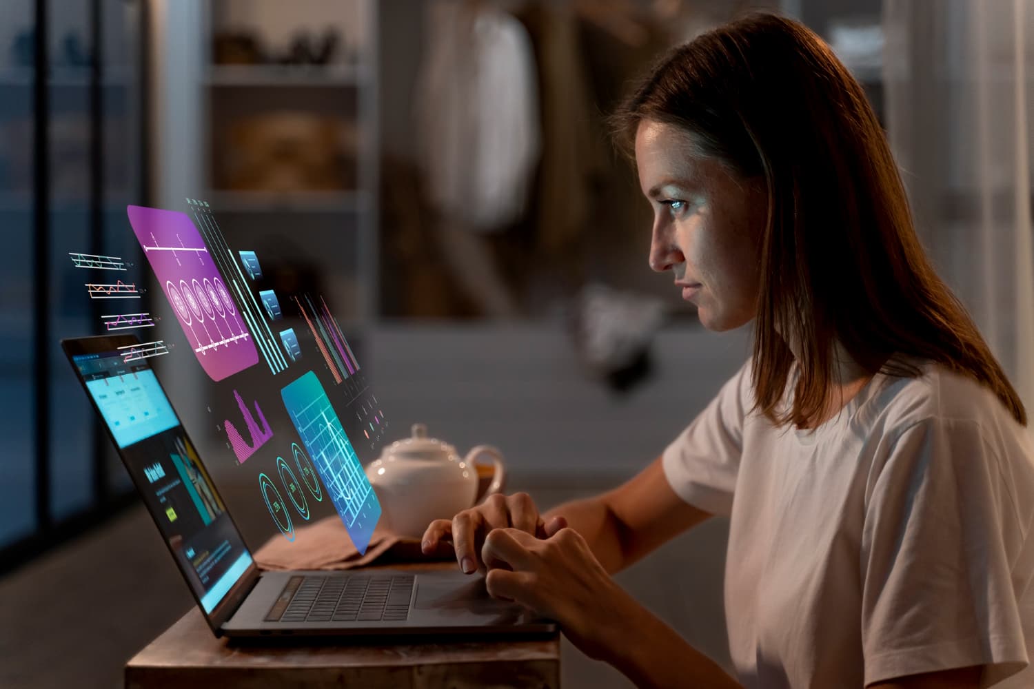 Woman working at a computer with holographic data display