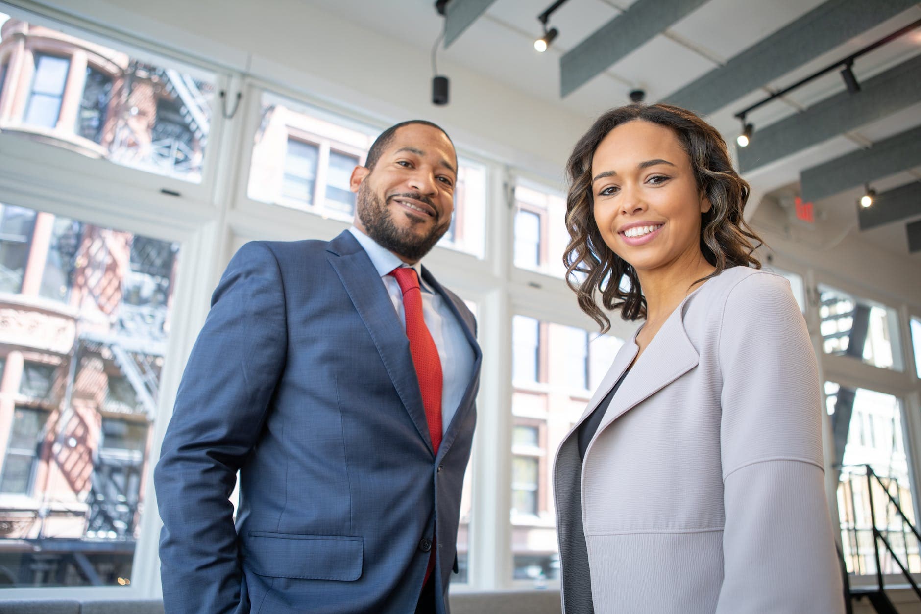 Two professionals smiling in an office setting